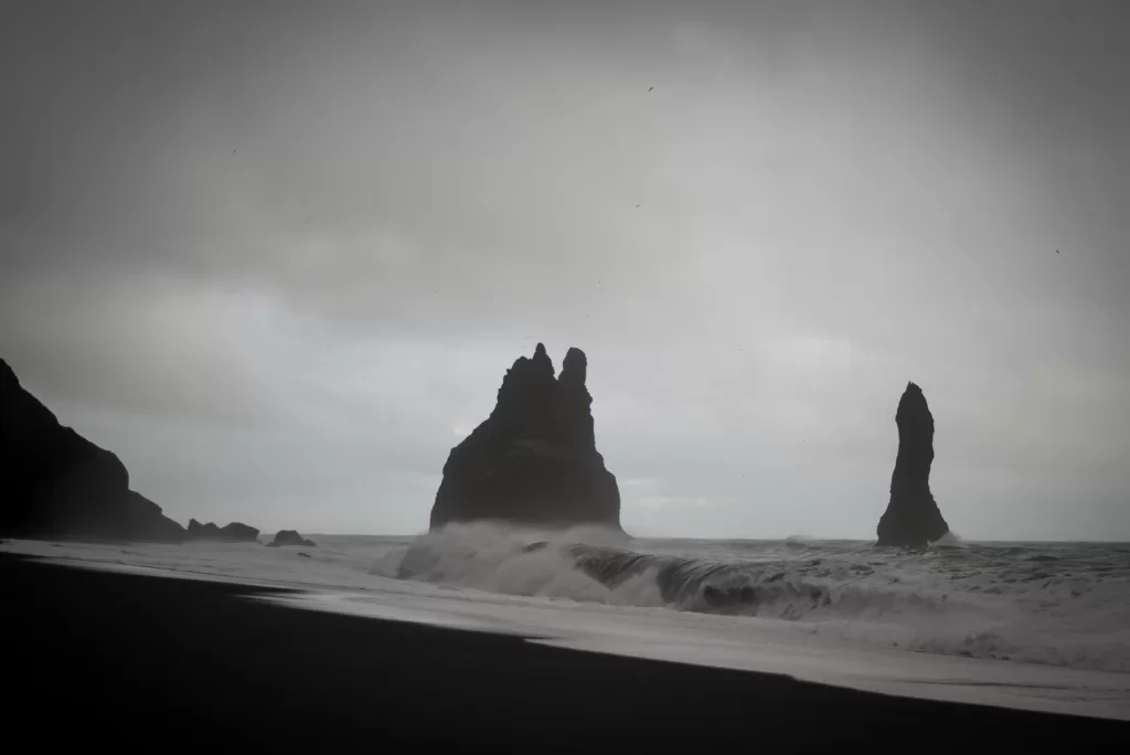 The cost of traveling to Iceland can be high, but the black sand beach is a free attraction. 